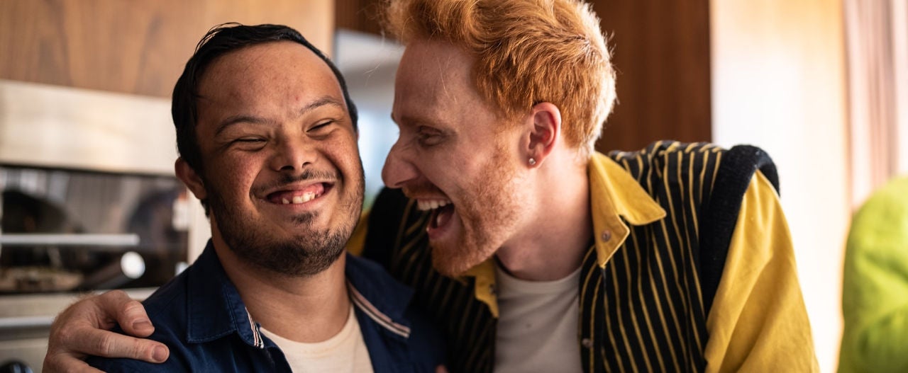 Two people hugging each other