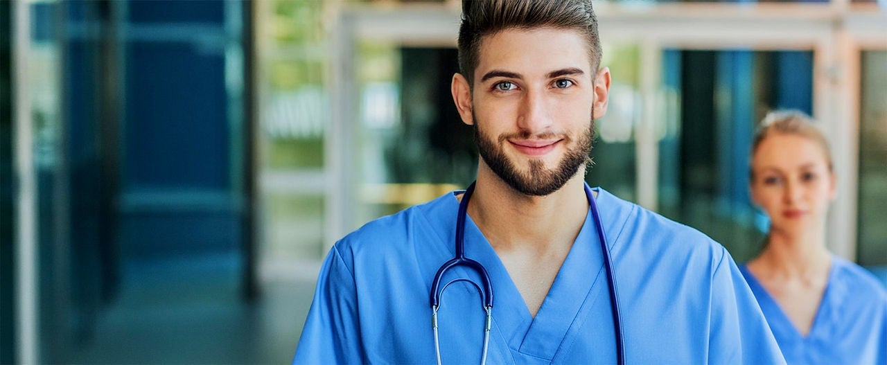 Health worker in blue uniform with stethoscope in hospital